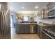 Well-equipped kitchen with stainless steel appliances, gray cabinets, and an island with bar seating at 3728 Juanita May Ave, North Las Vegas, NV 89032