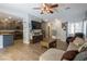 Comfortable living room with wood-look tile, ceiling fan, and open access to the kitchen at 3728 Juanita May Ave, North Las Vegas, NV 89032