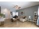 Bright living room featuring neutral paint, wood-look tile flooring, and modern furnishings at 3728 Juanita May Ave, North Las Vegas, NV 89032