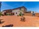 The expansive backyard features a small tree, a brick privacy wall, and a neutral colored two-story home at 3821 E Summit Ave, Pahrump, NV 89061