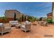 Inviting backyard with desert landscaping with patio furniture arranged on a concrete patio at 3821 E Summit Ave, Pahrump, NV 89061