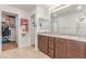 Bathroom featuring double sinks, vanity, and a large walk-in closet at 3821 E Summit Ave, Pahrump, NV 89061