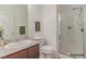 Clean bathroom with a glass-enclosed shower, granite vanity, and neutral color scheme at 3821 E Summit Ave, Pahrump, NV 89061