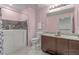 Modern bathroom featuring a walk-in tub, double vanity, and updated lighting at 3821 E Summit Ave, Pahrump, NV 89061