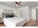 Comfortable bedroom with a ceiling fan, white walls and natural light from the open doorway and three botanical wall prints at 3821 E Summit Ave, Pahrump, NV 89061