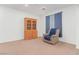 Neutral bedroom featuring a wood china cabinet and a beige recliner chair at 3821 E Summit Ave, Pahrump, NV 89061