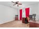 Bedroom featuring ceiling fan, carpeting, a window with red curtains, desk and wall-mounted TV at 3821 E Summit Ave, Pahrump, NV 89061