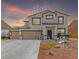 Charming two-story home featuring a three-car garage and desert-style landscaping with rock features at 3821 E Summit Ave, Pahrump, NV 89061