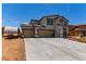 Charming two-story home with a three-car garage, desert landscaping and a long driveway at 3821 E Summit Ave, Pahrump, NV 89061