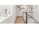 Second floor hallway with view of the staircase and bedroom access at 3821 E Summit Ave, Pahrump, NV 89061