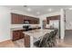 Well-equipped kitchen with granite countertops, dark wood cabinetry, stainless steel appliances, and kitchen island at 3821 E Summit Ave, Pahrump, NV 89061
