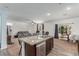 Kitchen island with granite countertop opens up to living room with stainless steel dishwasher and backyard access at 3821 E Summit Ave, Pahrump, NV 89061