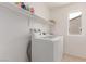 Laundry room with newer white washer and dryer and overhead storage at 3821 E Summit Ave, Pahrump, NV 89061