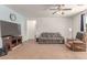 Spacious living room featuring a mounted television, sofa and beige recliner at 3821 E Summit Ave, Pahrump, NV 89061