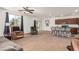 Spacious living room with neutral carpeting, ceiling fan, and access to kitchen and backyard at 3821 E Summit Ave, Pahrump, NV 89061