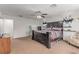 Bright bedroom with a ceiling fan, neutral walls and carpet, and a large bed at 3821 E Summit Ave, Pahrump, NV 89061