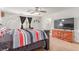 Bedroom showcasing a large TV, ceiling fan, and decor with windows allowing natural light at 3821 E Summit Ave, Pahrump, NV 89061