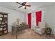 Well-lit home office featuring a bookshelf, desk, and cozy seating area at 3821 E Summit Ave, Pahrump, NV 89061