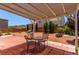 Backyard patio with grill, table, chairs and shaded pergola; ideal for outdoor dining at 3821 E Summit Ave, Pahrump, NV 89061