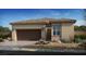 Charming single-story home featuring a neutral color palette, well-manicured front yard, and an attached two-car garage at 4140 E Brusca Way, Pahrump, NV 89061
