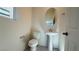 Powder room with pedestal sink, oval mirror, and white fixtures at 4705 Parkarbor Ave, Las Vegas, NV 89141