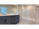 Modern bathroom features a double vanity with a tub and shower combo at 4705 Parkarbor Ave, Las Vegas, NV 89141