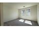 Bright bedroom with carpet flooring and two windows allowing for natural light at 4705 Parkarbor Ave, Las Vegas, NV 89141
