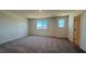 Spacious bedroom with carpet flooring and two windows that provide natural light at 4705 Parkarbor Ave, Las Vegas, NV 89141