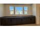Bright dining area featuring granite countertop and dark brown cabinets at 4705 Parkarbor Ave, Las Vegas, NV 89141