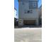 Two-story home with gray siding and stone accent and open garage at 4705 Parkarbor Ave, Las Vegas, NV 89141