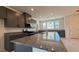 Open kitchen featuring gray cabinets, granite countertops, and a large center island at 4705 Parkarbor Ave, Las Vegas, NV 89141