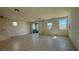 Spacious living room featuring tile floors, large windows, and a sliding door to the outside at 4705 Parkarbor Ave, Las Vegas, NV 89141