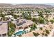 Desert home featuring a kidney-shaped pool with jacuzzi, covered patio, and lush landscaping at 5162 Estasi St, Las Vegas, NV 89135
