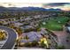 Golf course home with solar panels, mature landscaping, adjacent to the green with a pond and mountain backdrop at 5162 Estasi St, Las Vegas, NV 89135