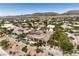 Desert home featuring a kidney-shaped pool, covered patio, desert landscaping and mountain views at 5162 Estasi St, Las Vegas, NV 89135