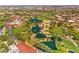 Expansive aerial view showcasing a luxury community with lush landscaping, water features, and a golf course at 5162 Estasi St, Las Vegas, NV 89135