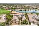 Desert home featuring a well-manicured front yard, solar panels, desert landscaping, and pond access, showcasing sustainability and beauty at 5162 Estasi St, Las Vegas, NV 89135