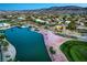 Golf course home with pond, lush greenery, desert landscaping, and Mountain Views, showcasing a premier outdoor living space at 5162 Estasi St, Las Vegas, NV 89135