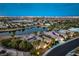 Captivating aerial view of a lakeside home with solar panels and a sprawling city skyline in the distance at twilight at 5162 Estasi St, Las Vegas, NV 89135