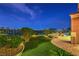 Beautifully landscaped backyard and outdoor entertaining with a pool and views of the lake at 5162 Estasi St, Las Vegas, NV 89135