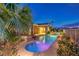 Beautiful backyard pool and spa area featuring lush landscaping and a covered patio at 5162 Estasi St, Las Vegas, NV 89135