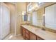 Bathroom showcasing double sinks, granite countertops, and decorative mirrors at 5162 Estasi St, Las Vegas, NV 89135