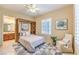 Comfortable bedroom boasts plantation shutters, neutral decor, and stylish rug at 5162 Estasi St, Las Vegas, NV 89135