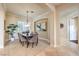 Elegant dining room with natural light, comfortable seating, stylish décor, and an open doorway at 5162 Estasi St, Las Vegas, NV 89135
