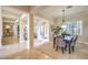 Bright dining room featuring a large dining table, elegant chandelier, and views into the living room at 5162 Estasi St, Las Vegas, NV 89135