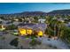 Charming desert home boasting mature landscaping, inviting pool, scenic mountain views, and illuminated windows at 5162 Estasi St, Las Vegas, NV 89135