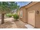 Exterior of the home showing mature trees and gravel landscaping, with entry door at 5162 Estasi St, Las Vegas, NV 89135