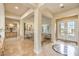 Spacious foyer with elegant marble floors, grand pillars, and abundant natural light from the front door at 5162 Estasi St, Las Vegas, NV 89135