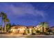 Inviting home exterior featuring a well-maintained lawn and tasteful landscaping at night at 5162 Estasi St, Las Vegas, NV 89135