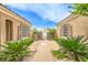 Inviting front yard with desert landscaping and decorative gate between the house and the detached garage at 5162 Estasi St, Las Vegas, NV 89135